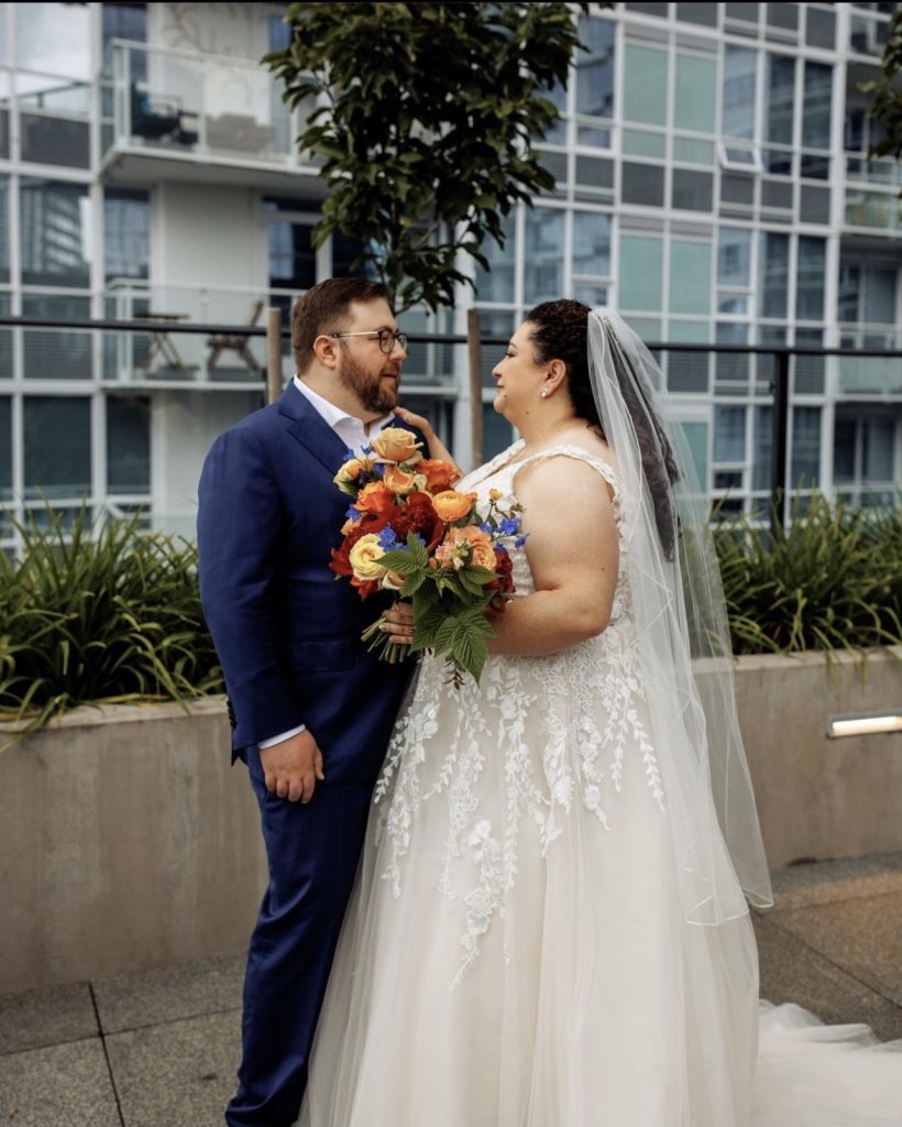 Bride and groom portrait city backdrop colorful bouquet wedding Events by Aubrie
