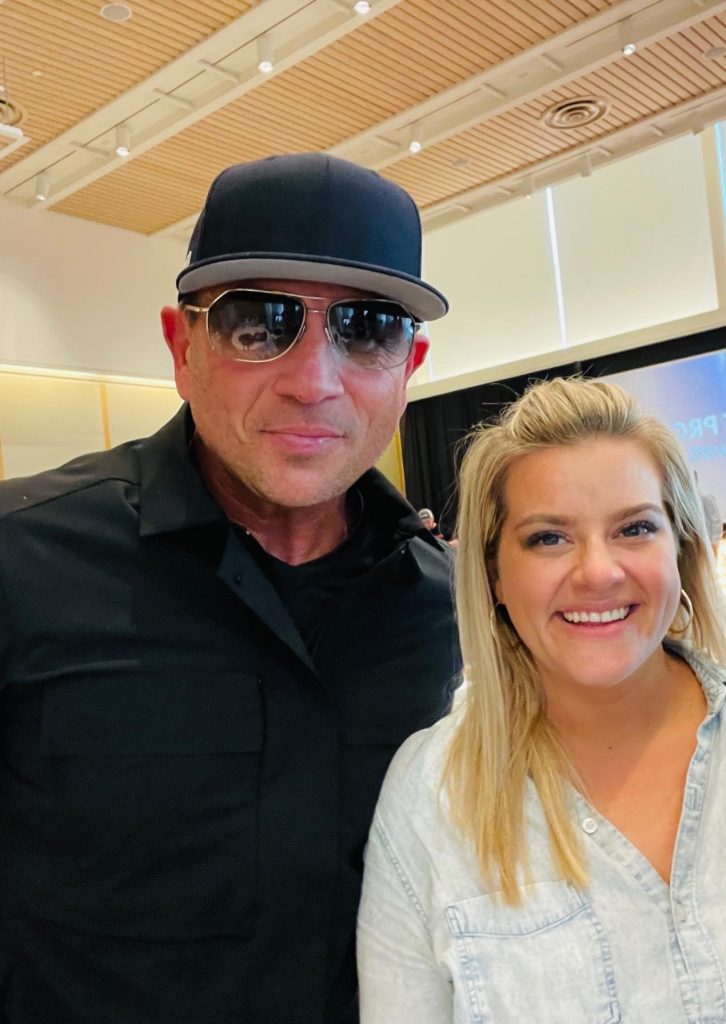 Event attendee posing with guest speaker at corporate conference