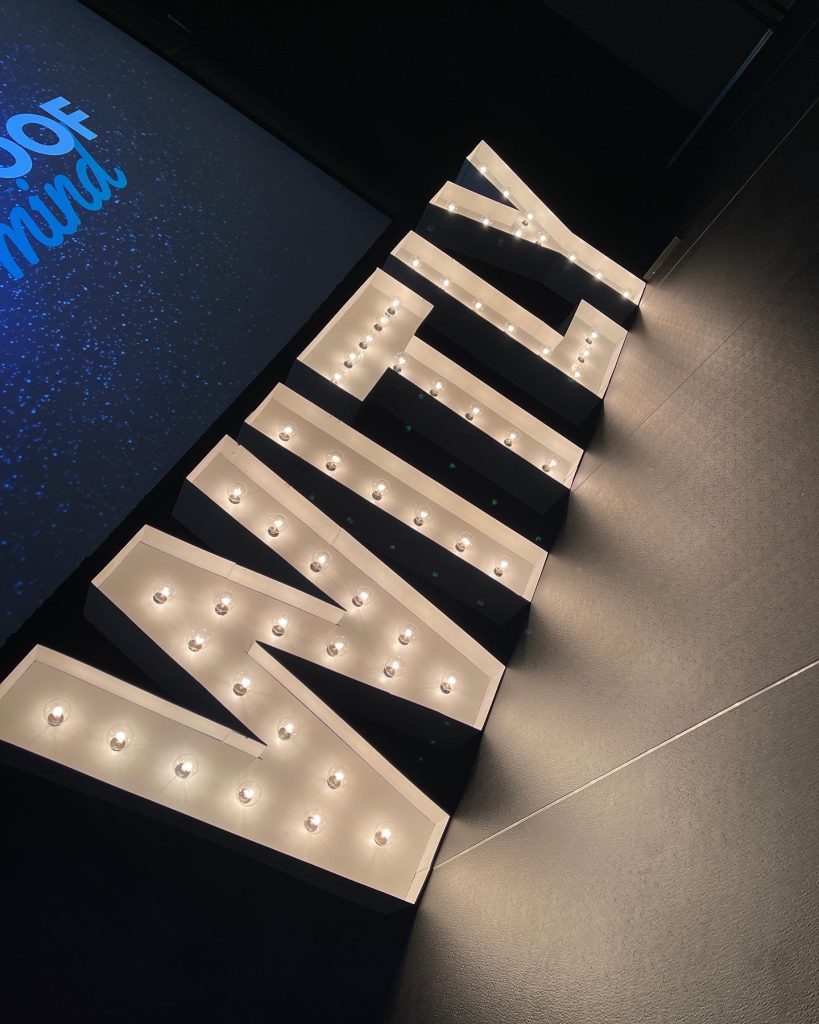 Illuminated WITLY event sign display at corporate event venue