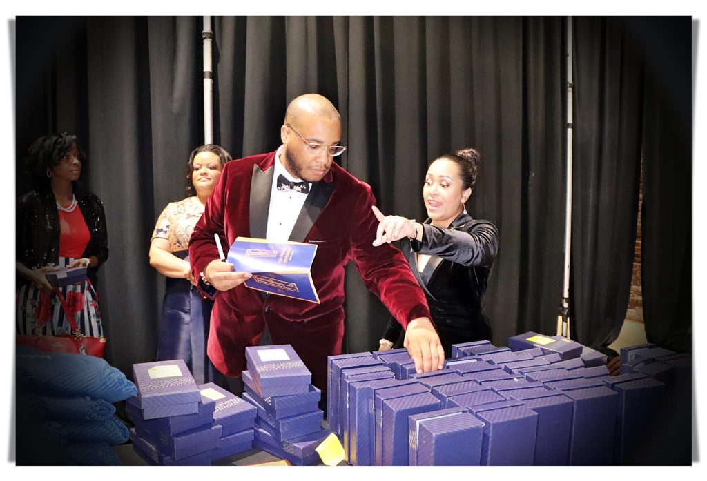 Corporate event registration table gift boxes guest check-in Events by Aubrie
